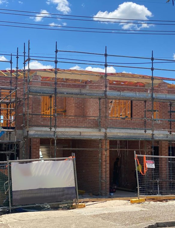 Double-brick duplex framed and topped out, ready for roofing